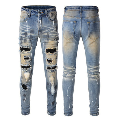 Men's Blue Jeans with Black Patches, Distressed Paint, and Ripped Details